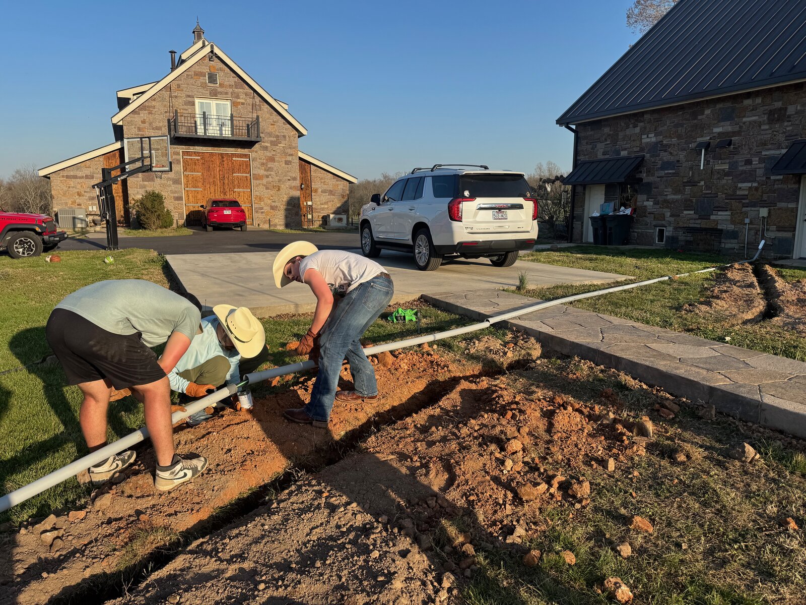 GHR crew installing an irrigation line along a driveway