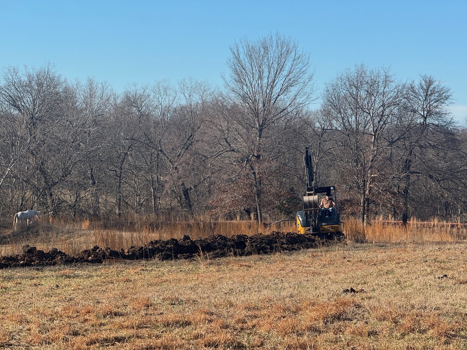 GHR mini excavator doing dirt work in a field