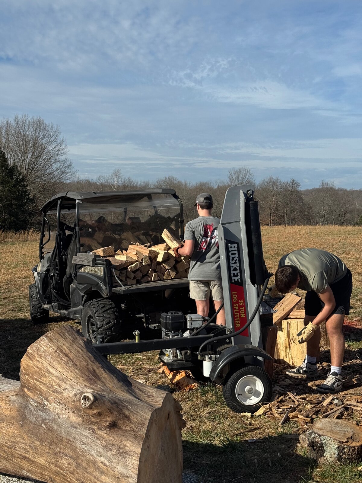 GHR crew splitting firewood with a log splitter
